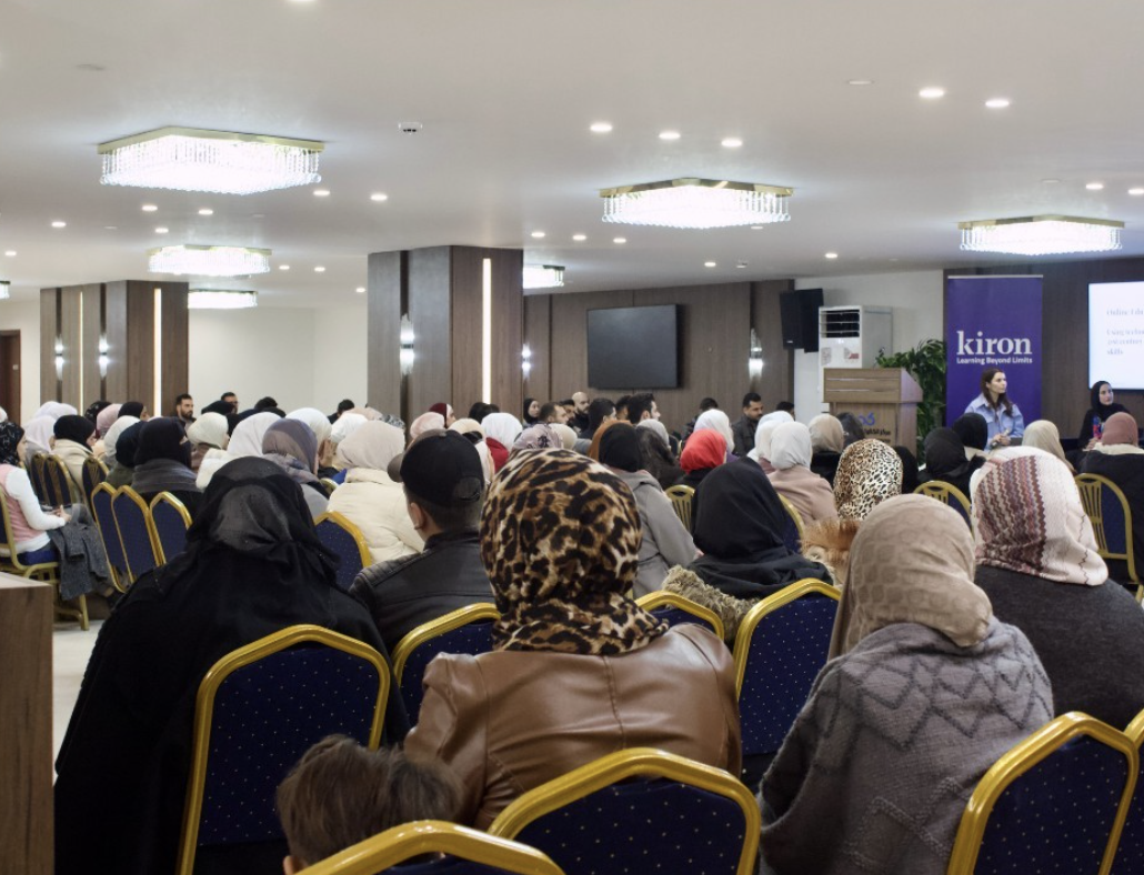 A big audience listening to a Kiron panel